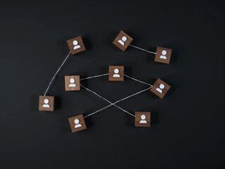 Wooden Cubes Connected with Lines on Blue Background Representing Social Network and Organizational Structure, Illustrating Teamwork, Digital Communication, and Business Collaboration