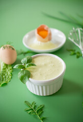 Green background and products for making fresh mayonnaise