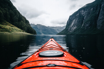 Kayaking in a peaceful lake by towering mountains