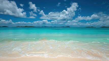 Obraz premium Serene Harmonies: The Enchanting Dance of Beach Waves Under a Canopy of Azure Skies and Cotton-Candy Clouds – A Captivating Ode to Coastal Tranquility and Nature's Artistry