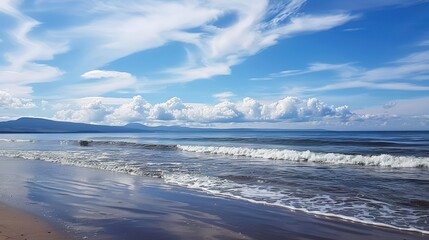 Obraz premium Serene Harmonies: The Enchanting Dance of Beach Waves Under a Canopy of Azure Skies and Cotton-Candy Clouds – A Captivating Ode to Coastal Tranquility and Nature's Artistry