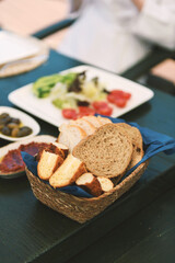 A detailed close up of freshly baked bread and simit from the breakfast spread, showcasing their golden crust and texture