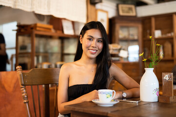 Portrait of beautiful young woman in coffee shop