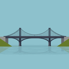 Obraz premium A modern bridge spans a serene river under a clear blue sky, symbolizing connectivity