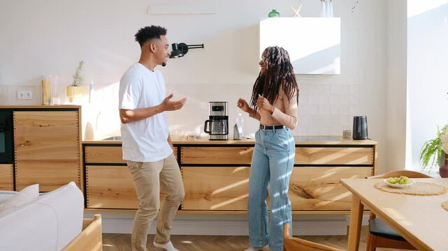 A man and a woman dance and talk while smiling