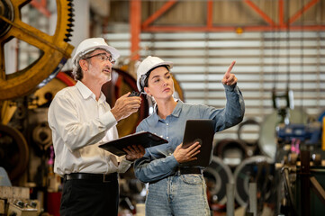 woman engineer assistant secretary in helmet inspection check control heavy machine construction installation in industrial factory with boss manager. Boss and partnership check maintenance factory