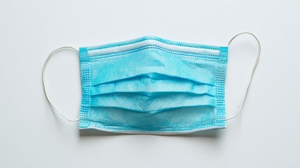 Closeup of a single blue face mask on white background, protection and hygiene