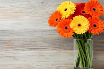 Fototapeta premium Bright gerbera daisies in a simple vase on a rustic wooden table