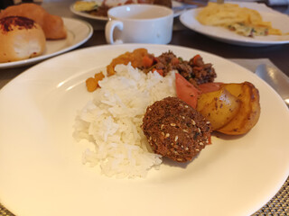 Delicious Breakfast Buffet Plate with Rice, Falafel, and Savory Meat Dish
