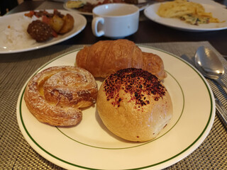 Fresh Pastries and Croissant on a White Plate at a Breakfast Buffet