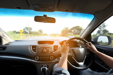Man driver hands holding the car steering panel