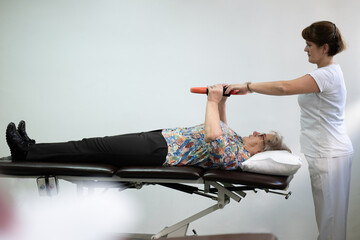 Physiotherapy Session with Elderly Woman Using Exercise Ring