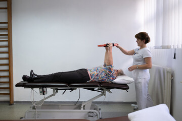 Physiotherapy Session with Elderly Woman Using Exercise Ring