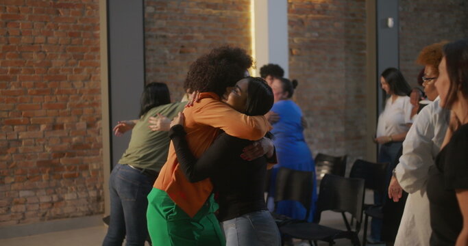 Diverse congregation members exchanging hugs and smiles in a modern church setting, creating a sense of community, connection, and shared spirituality