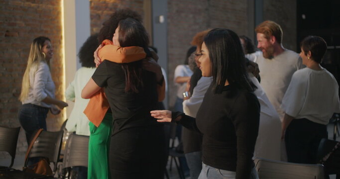 Diverse congregation members exchanging hugs and smiles in a modern church setting, creating a sense of community, connection, and shared spirituality