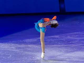 Young Skater Performing a Spin on the ice Rink © GioRez