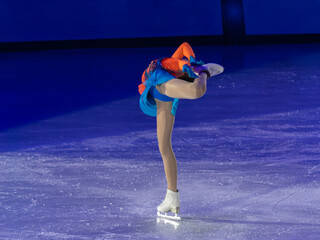 Young Skater Performing a Spin on the ice Rink © GioRez