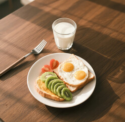Sunny Breakfast with Fried Eggs, Toast, Kiwi, and Milk &ndash; Healthy Morning Meal on Wooden Table
