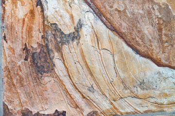 Rust and corrosion on weathered stone plate.