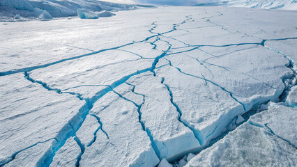 Cracked Arctic Glacier Surface With Deep Blue Crevasses