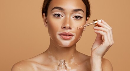 A woman with vitiligo applies facial serum, showcasing skincare and beauty.