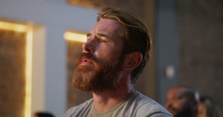 Man in prayer with hands clasped, eyes closed, deep connection to faith, Christian worship gathering, unity in spirituality, devotion in church setting