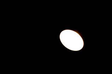 A white light is shining on a black background