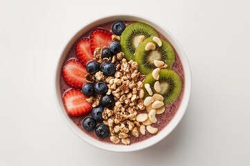 Colorful smoothie bowl with fruit, nuts and granola.