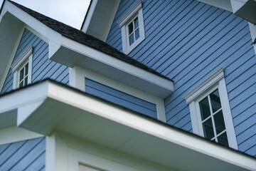 Blue wooden walls and multiple windows give the house more dimension.
