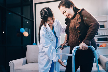 Young doctor examines senior patient's leg.