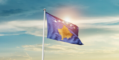 Kosovo national flag waving in beautiful sky with mast. A proud moment flag waving with sunlight.