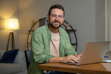 Man sitting at desk working on laptop