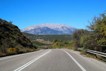 On the road with view at Mount Parnassus mountain range in Greece