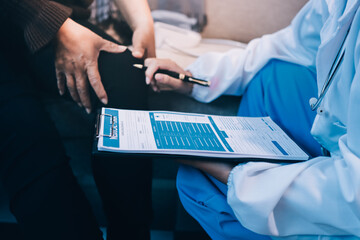 Young doctor examines senior patient's leg.