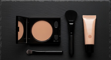 Gender-neutral makeup tools for men: foundation, powder, and brushes on textured black surface