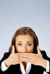 Wow! Expressive surprised, astonished shocked businesswoman keep hands over face. Amazed corporate business woman cover mouth, isolated grey gray background. Vertical banner image with free text space