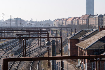 Copenhagen rail infrastructure from above with tracks converging and early light casting soft shadows on the city background, ideal for urban planning and travel themes.