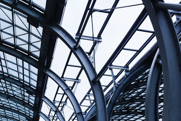Modern steel and glass architecture. Industrial construction detail with metal beams and transparent roof. Urban structural engineering with geometric framework. Contemporary city infrastructure.