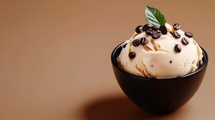 A bowl of creamy coffee ice cream with visible coffee beans on top, placed on a soft brown background with plenty of open space. 