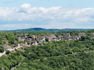 Fototapeta premium The settlement of l'Hospitalet above Alzou Canyon and Dordogne Valley, at the top of the Voie Sainte facing Rocamadour relics, way down the cliff face, seen from the Corniche promenade 