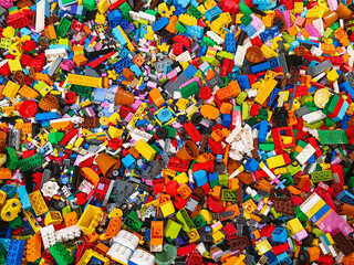 Naklejka premium NAKHON PATHOM,THAILAND - JANUARY 17 ,2025 : Top view A pile of multicolor of many Lego toy blocks in various shapes and different sizes at Central salaya. Toys and games. Leisure and recreation.