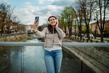 Young caucasian woman using smartphone to take self portrait or video call
