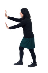 side view of woman holding or squeezing a wall or something imaginary on white background