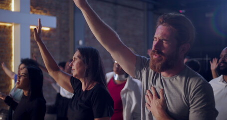 People raising hands in worship during a spiritual gathering in a church, expressing faith, devotion, and unity in a heartfelt moment of prayer