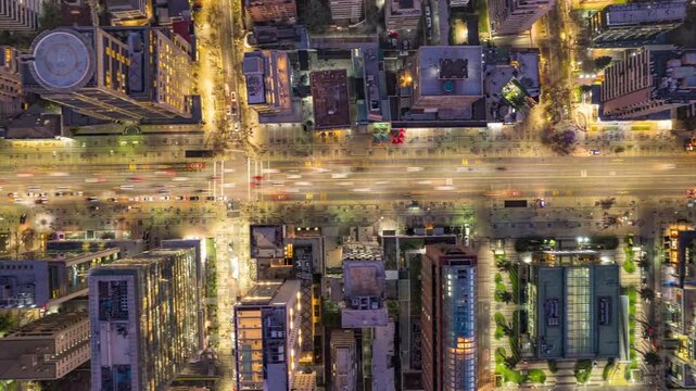 Santiago, Chile &ndash; May 23, 2024: Drone hyperlapse with top-down view advancing along Apoquindo Avenue in Las Condes at night, showing traffic, lights, and tall buildings.
