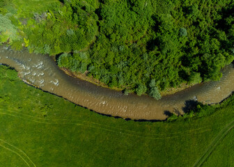 Aerial view of the Tarnava Mica river polluted with salt from the Praid salt mine - Romania