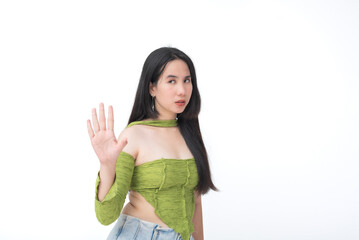 Teen girl raises her hand in a stop sign while giving a disapproving expression, clearly annoyed or...