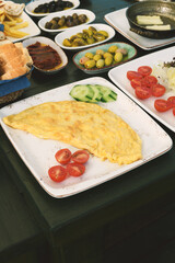 A detailed close-up of a golden, fluffy omelet from the luxurious breakfast spread, showcasing its perfect texture