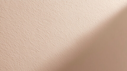 Beige textured wall with diagonal shadow