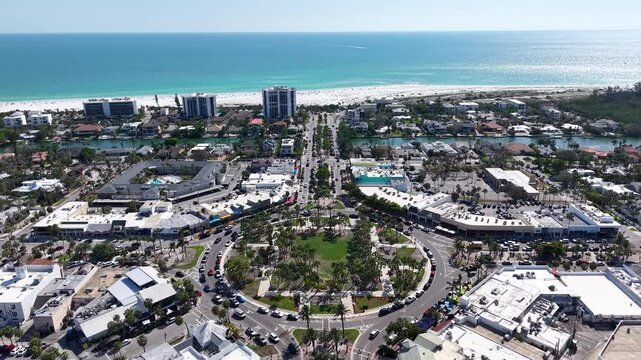 Beautiful aerial cinematic view of Sarasota, the magnificent white sand beach, and its iconic St. Armands Circle